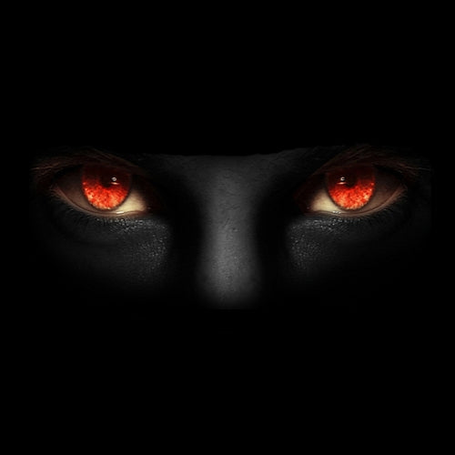 Glowing red eyes staring out of a shadowed face in the dark. The Crawl Space.